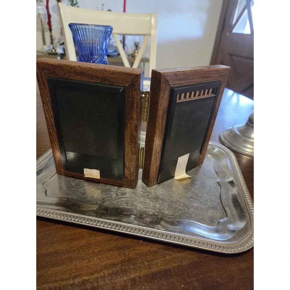 vintage bifold photo frame features a dark brown wood-grain finish and brass...